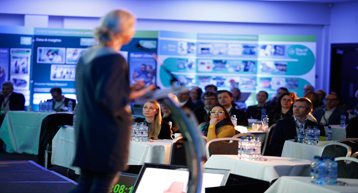 Woman on stage speaking at conference